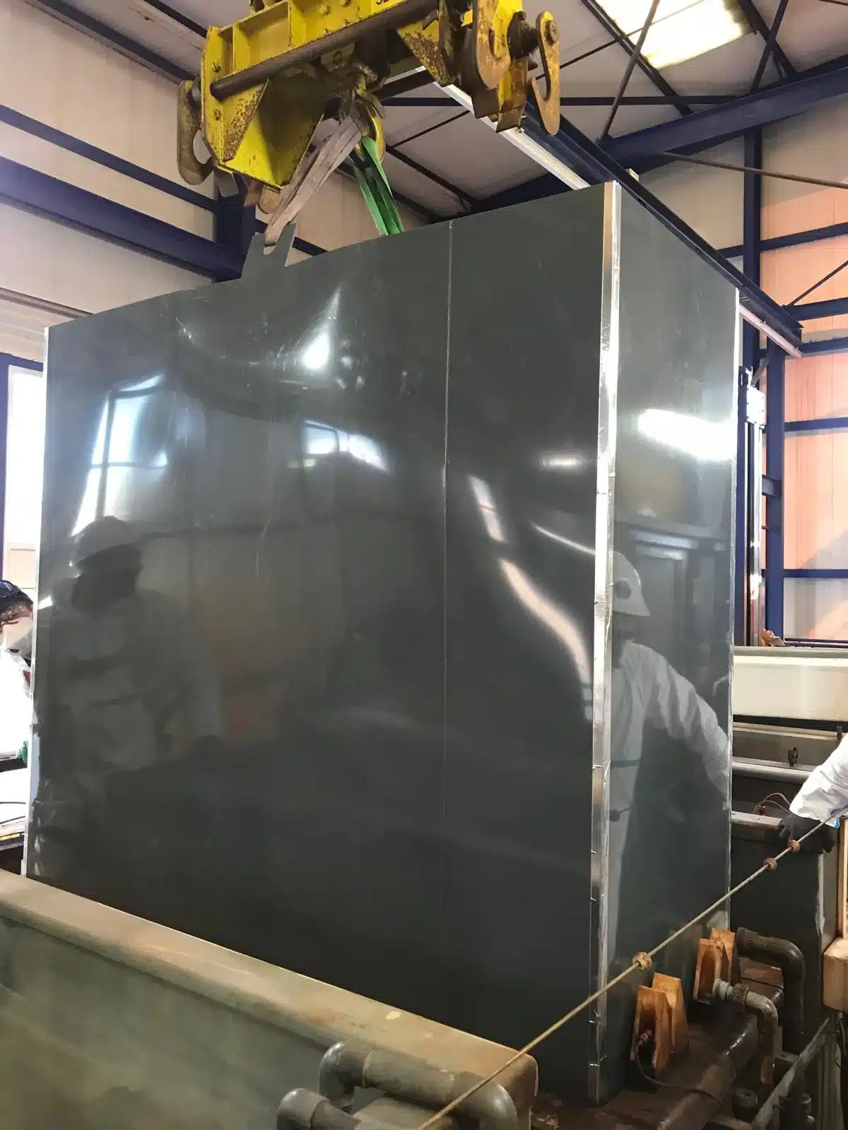 grande cuve PVC manipulée par pont roulant — atelier USIPANEL